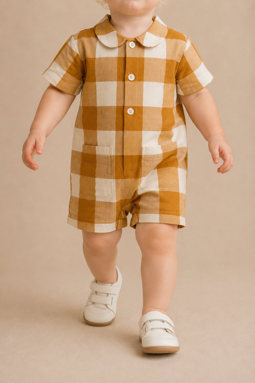 Faceless child model in an ochre gingham short playsuit